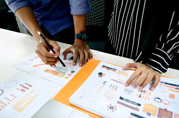 A stock image of two people reviewing a presentation.